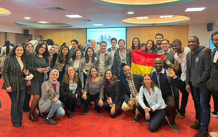 Large group of Chevening students kneeling and standing, facing the camera