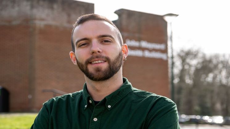 Elias Primetis standing in front of JMS building on campus