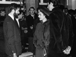 Her Majesty the Queen talks to a student in a building on campus