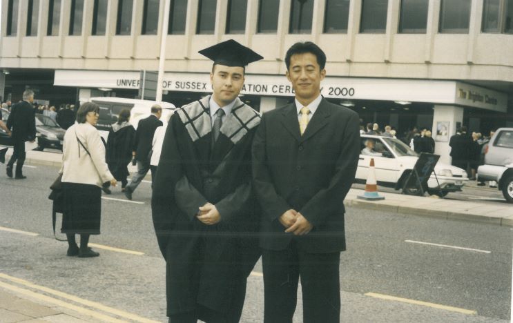Graduate and father outside the Brighton Centre on graduation day