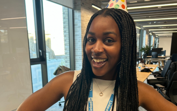Jamila Campbell-Allen stood wearing a polka dot party hat and a LinkedIn lanyard.