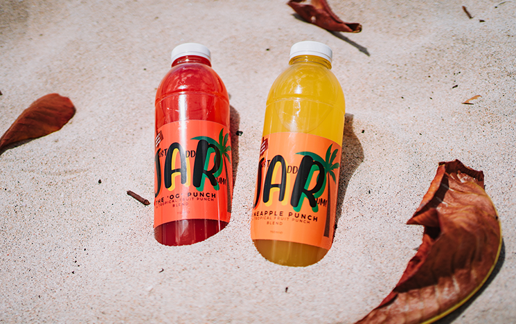 Two JAR products lying in a bed of sand.