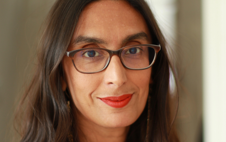 Portrait of Dr Sheela Banerjee wearing red lipstick.