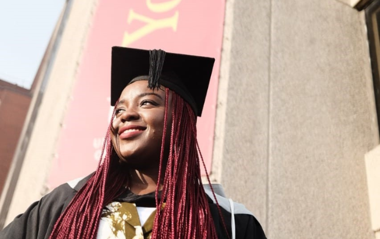 Jennifer standing outside the Brighton Centre at her graduation ceremony