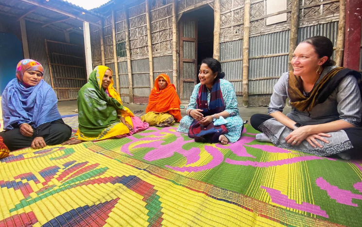 Tanjila Mazumder Drishti sat on the floor on a colourful rug listening to female participants of BRAC's Ultra Poor Graduation Programme in Bangladesh.