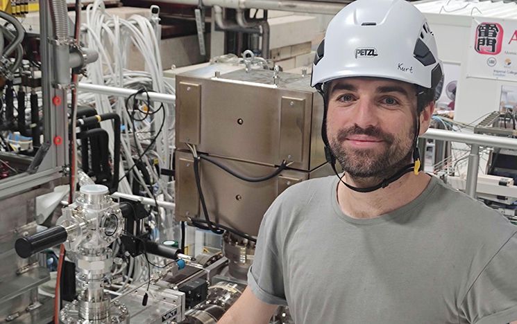Alberto Jesus Uribe Jimenez at CERN, standing next to the equipment of his experiment