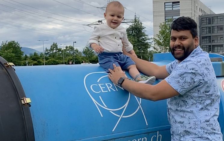 April Cridland's husband holding his young son on one of the CERN dipole magnets
