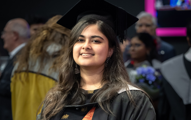Rimjhim Chakraborty in her graduation gown and mortar board.