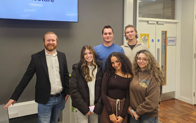 Shaun stood with five students from a University of Sussex lab he worked as a Doctoral Tutor for.