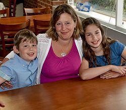 Professor Louise Serpell sitting with two children at a table