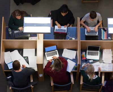 Arial image showing people working at individual desks in the library