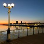 Lamppost by the sea at sunset