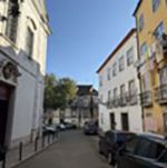 Street with cars parked and houses on both sides
