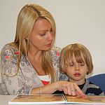 Sophie Williams reads to a young boy.