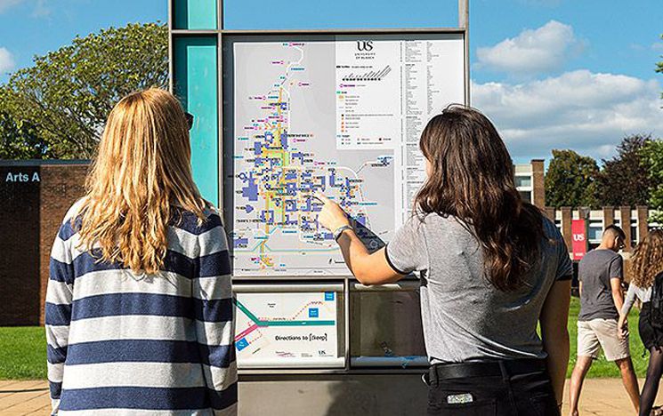 Students pointing to site map