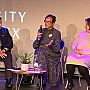 A seated Professor Valerie Hey speaks into a microphone on stage following Louise Morley's presentation