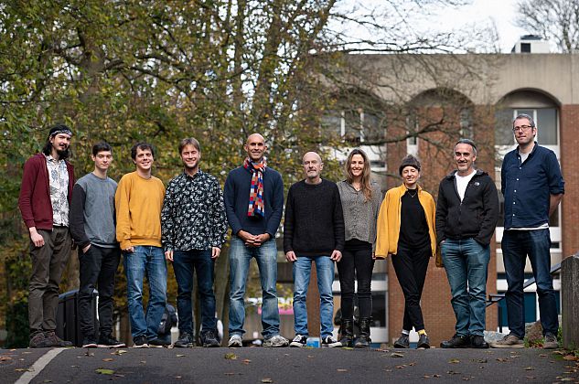 Informatics-based team members standing outdoors in a line