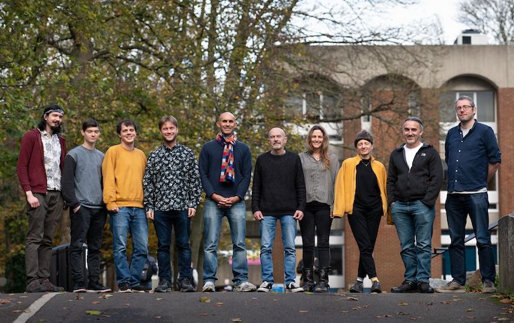 Informatics-based team members standing outdoors in a line