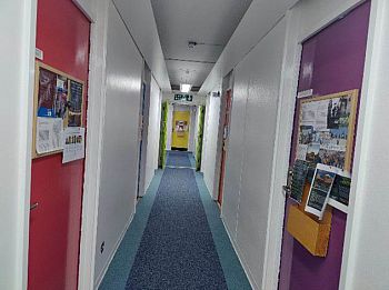 picture of arts c corridor with posters on office doors