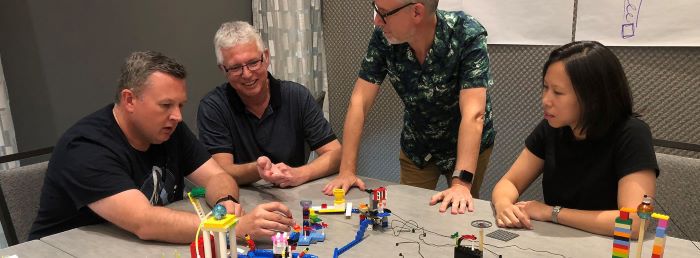Four participants taking part in a Lego teaching session