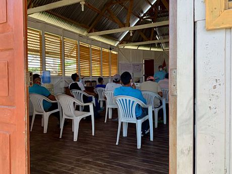 A room full of students attending a meeting under Covid-19 conditions and socially distancing