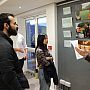 Group of people listening to SSRP co-Director john Thompson during the opening evening while standing in the exhibition space