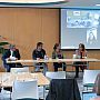 Group of people sitting on chairs and listening to our "Equitable Partnerships" panel feat. SSRP researchers and their project partners from abroad. The Chair Prof Robin Banerjee can be seen facilitating the session, while three of the panelists are seated to the right of Robin and the remaining two online panelists are pictured via a big screen