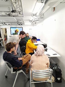 mixed group of students at work in the lab space using soldering equipment