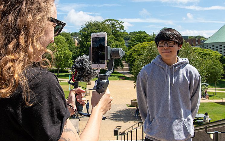 A member of staff filming someone for social media publication