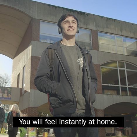 A video still showing a man on campus with one line of sub-title