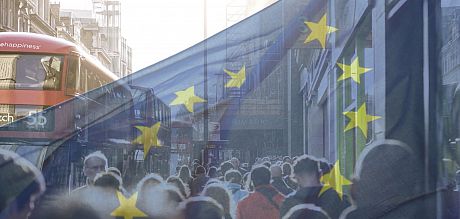 A photo of an EU flag flying over a crowd in a UK city