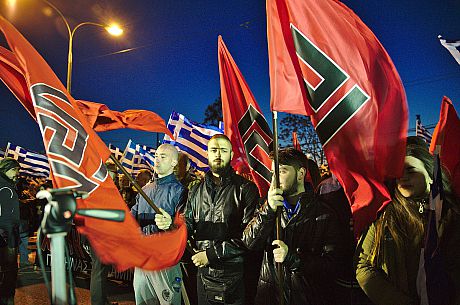A photo of Golden Dawn members holding up the party's flag