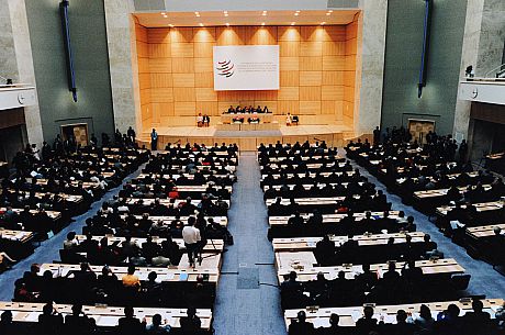 A photo of a meeting of the World Trade Organisation, with a large audience watching speeches on a stage