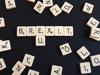 A photo of scrabble tiles spelling out 'Brexit' and 'EU'