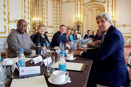 U.S. Secretary of State John Kerry sits with British Prime Minister David Cameron and other government officials from around the world on May 12, 2016, at Lancaster House in London, U.K., at the outset of a working breakfast preceding an anti-corruption summit meeting hosted by the British leader.