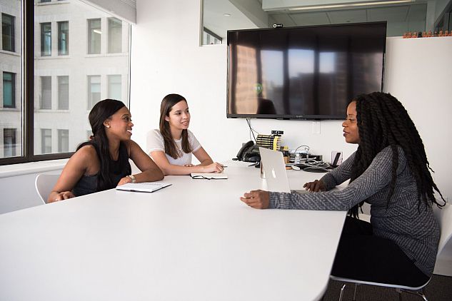 three colleagues working around a table