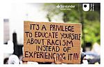 Image of a protest banner with anti-racist comment