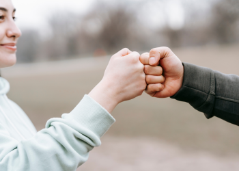 Two people sharing a fist bump
