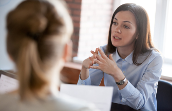 A woman explaining something to another woman