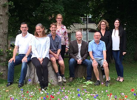 David enjoying a rare sunny English summer day with the team in our lovely meadow. David is seated and in the brown jacket.