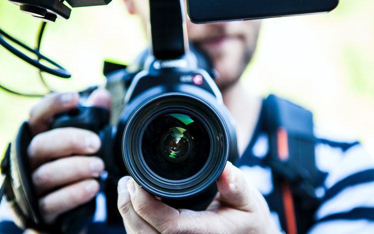 Video camera filming pointed at the screen and viewer