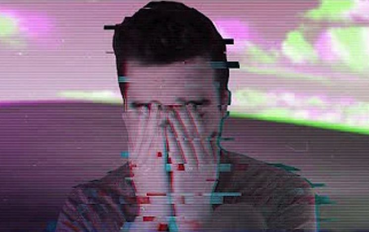 Still from 'Discontent' showing a distorted image of a man with his hands over his eyes