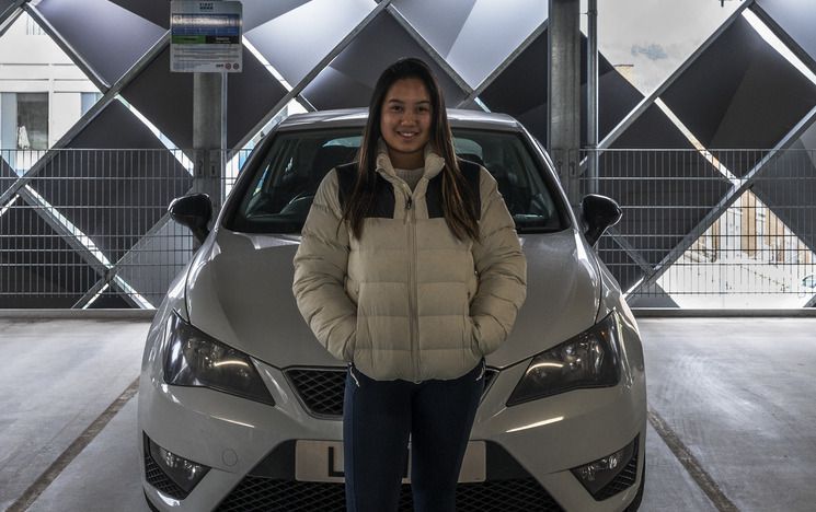 Women standing in front of car