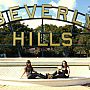 Two students sat in front of the Beverly Hills sign