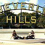 Two students sat in front of the Beverly Hills sign