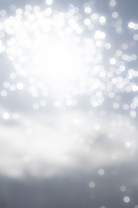 Raindrops on a window glitter in sunlight