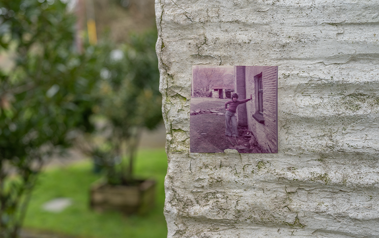 A sepia toned photo pinned to a wall