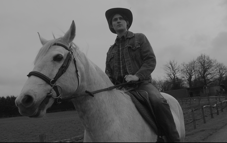 A man riding a white horse