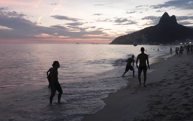 People playing football on a beach in Brazil