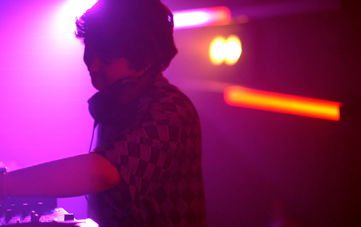 A person in glowing lights of a nightclub